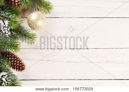 Christmas background with pine tree and bable decor on wood with copy space