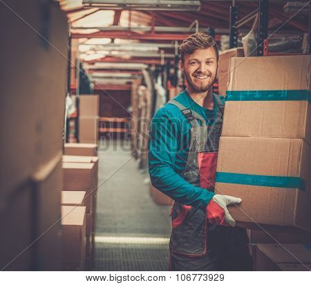 Porter carrying boxes in a warehouse 