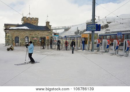 People walk at the upper Gornergratbahn railway station in Zermatt, Switzerland.