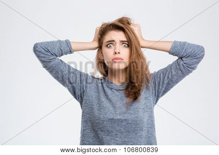 Portrait of a nerveous woman standing isolated on a white background