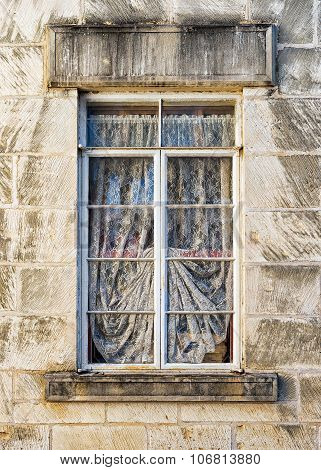 Weathered Window In A Limestone Wall