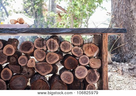 A Pile Of Wood Under A Table