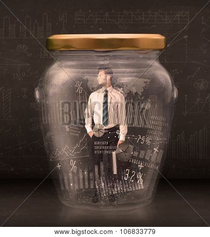 Businessman traped in jar with graph chart symbols concept on background