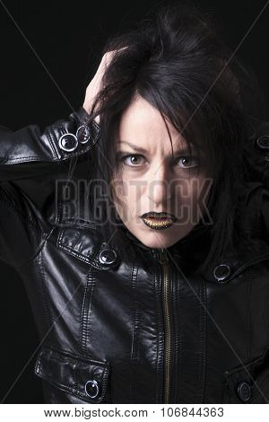 A gothic woman over a dark background,