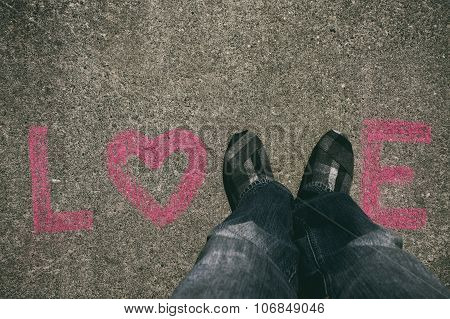 Word of LOVE written in chalk on concrete