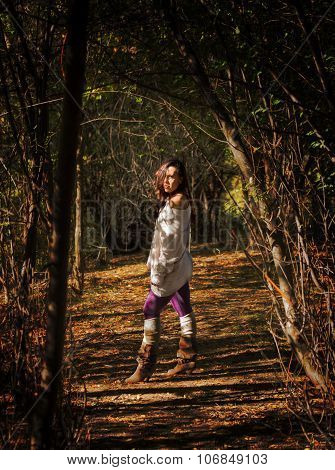 attractive lady in between natural ambient sun shinning through trees