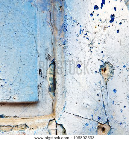 Dirty Stripped Paint In The Blue Wood Door And Rusty Nail