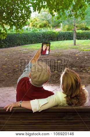Senior Man And Senior Woman Doing A self-portrait