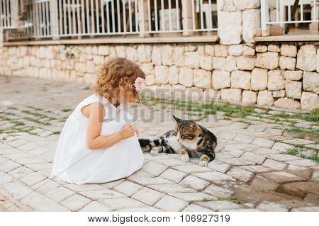 Little Girl Playing With Caton The Street