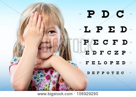Cute Little Girl Reviewing Eyesight On Chart.