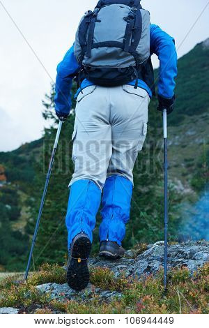 advanture man with backpack hiking on mountain forest