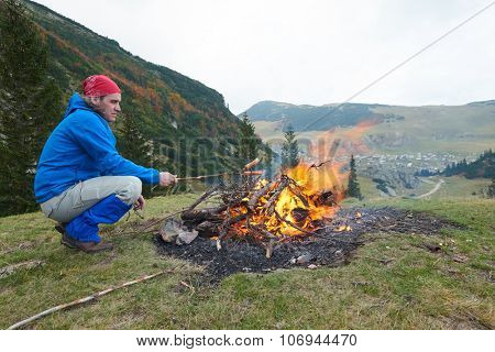 advanture man with backpack hiking on mountain forest