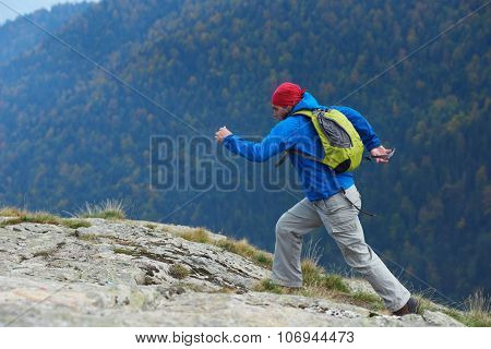 advanture man with backpack hiking on mountain forest