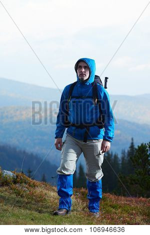 advanture man with backpack hiking on mountain forest