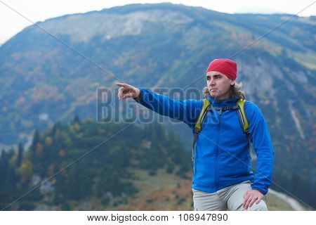 advanture man with backpack hiking on mountain forest