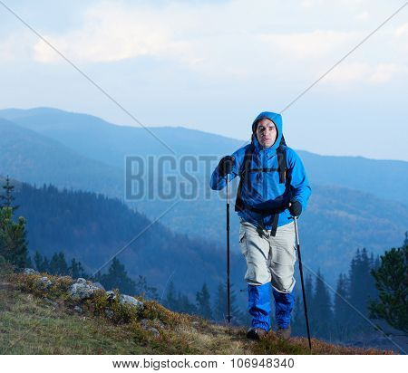 advanture man with backpack hiking on mountain forest