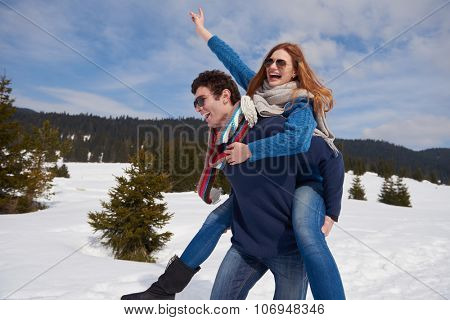 romantic winter  scene, happy young couple having fun on fresh show on winter vacatio, mountain nature landscape