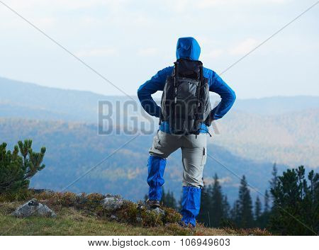 advanture man with backpack hiking on mountain forest