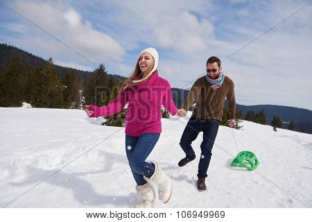romantic winter  scene, happy young couple having fun on fresh show on winter vacatio, mountain nature landscape