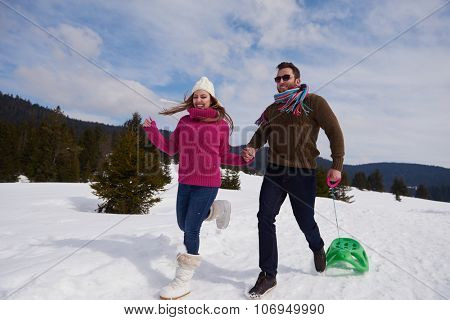 romantic winter  scene, happy young couple having fun on fresh show on winter vacatio, mountain nature landscape