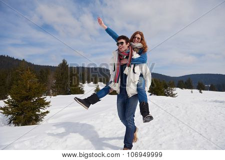 romantic winter  scene, happy young couple having fun on fresh show on winter vacatio, mountain nature landscape