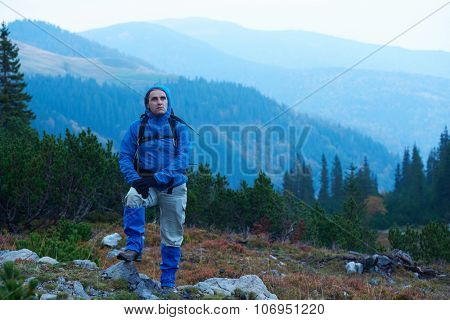 advanture man with backpack hiking on mountain forest