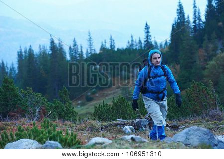 advanture man with backpack hiking on mountain forest