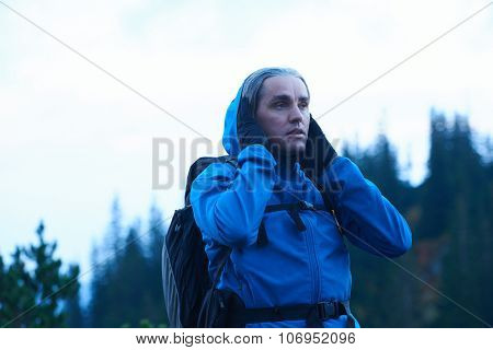 advanture man with backpack hiking on mountain forest
