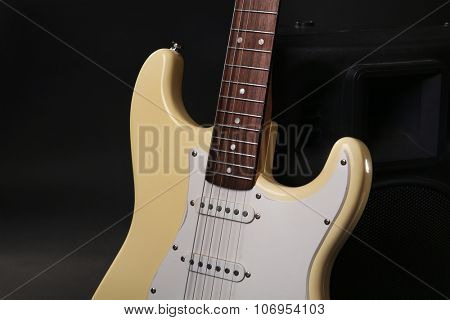 Electric guitar with musical equipment on dark background
