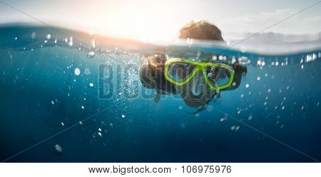 Close up split shot of the young lady snorkeling in the clear tropical sea