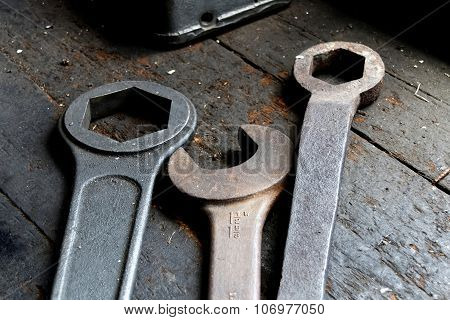 Three Old Wrech Laying On An Worn Wooden Table
