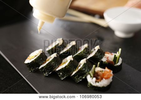Sushi master prepares futomaki