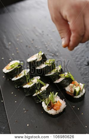 Classic thick rolls futomaki served on a stone plate