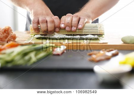 Sushi master turns sushi rolls