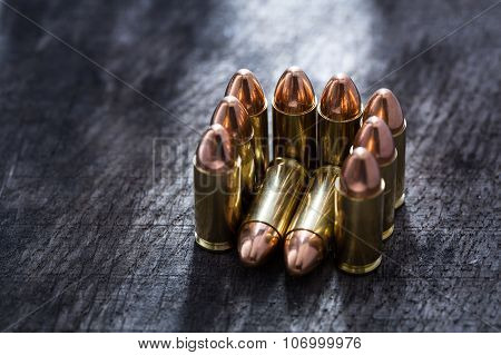 Composition of pistol copper cartridges stacked in a guest chair