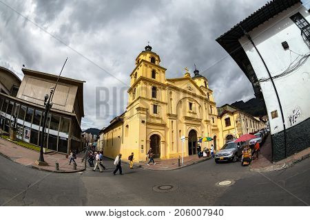 BOGOTA COLOMBIA - APRIL 23: Unidentified people relax in front of the primary cathedtral in Bolivar Square on April 23 2016 in Bogota Colombia.
