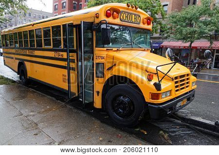 NEW YORK CITY USA September 13 2017 : School bus in Harlem. Harlem is a large neighborhood in the northern section of the New York City borough of Manhattan.