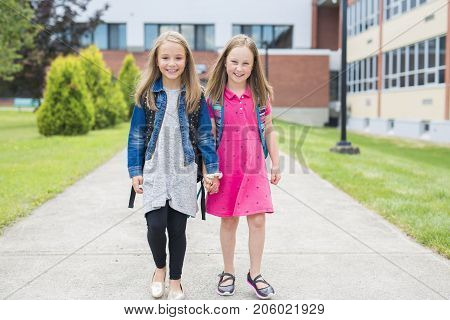 The Great Portrait Of School Pupil Outside Classroom Carrying Bags
