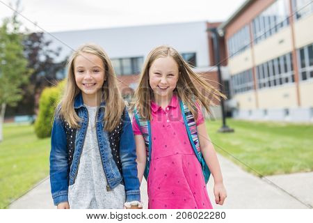 The Great Portrait Of School Pupil Outside Classroom Carrying Bags