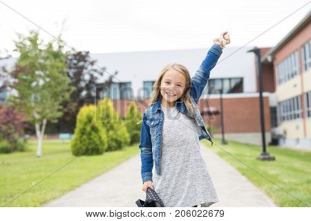The Great Portrait Of School Pupil Outside Classroom Carrying Bags