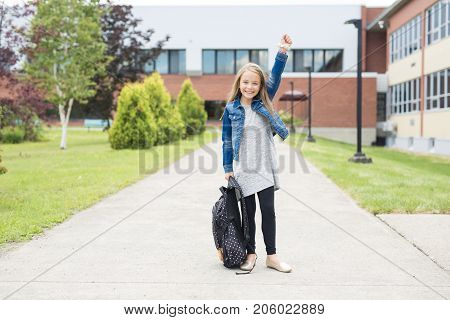 The Great Portrait Of School Pupil Outside Classroom Carrying Bags