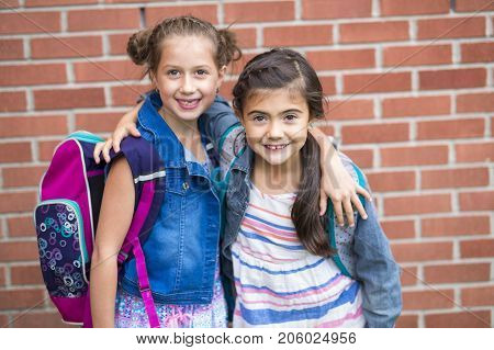 The Great Portrait Of School Pupil Outside Classroom Carrying Bags