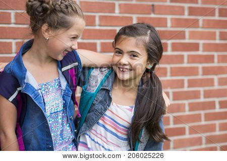 The Great Portrait Of School Pupil Outside Classroom Carrying Bags