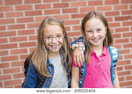 The Great Portrait Of School Pupil Outside Classroom Carrying Bags