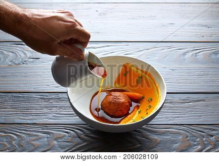 Dumpling of old cowtail with creamy carrot and its juice