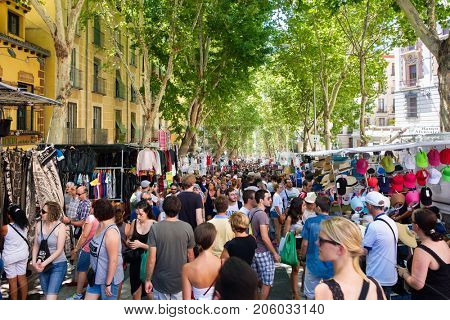 MADRID,SPAIN - AUGUST 6,2017 : People shopping at El Rastro, the most popular open air market in Madrid