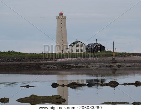 Lighthouse and two houses on the island Grotta, Reykjavik, Iceland.
