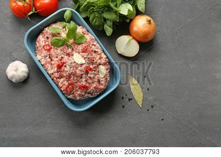 Baking dish with raw turkey meatloaf on table