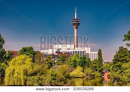 Kaiserteich park in Dusseldorf, Germany with Rheinturm tower in the background