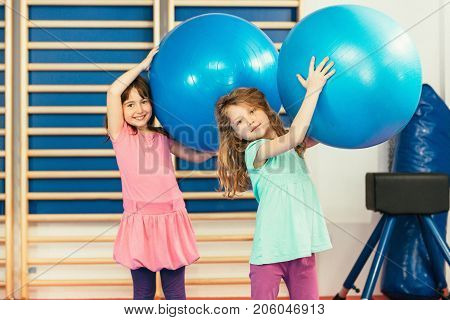 Two girls at physical education class color iage
